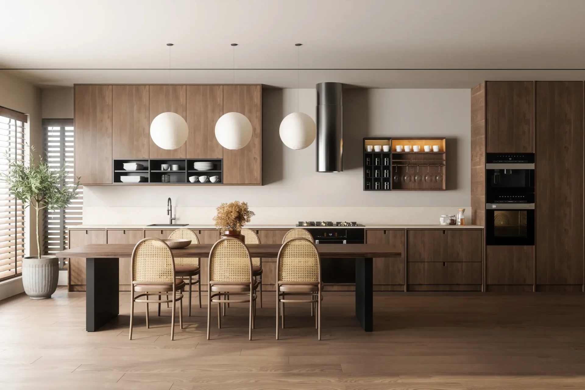Modern kitchen and dining space with warm wood cabinetry, white countertops, three round pendant lights, woven dining chairs, and a central island by Ahuva Newhouse.