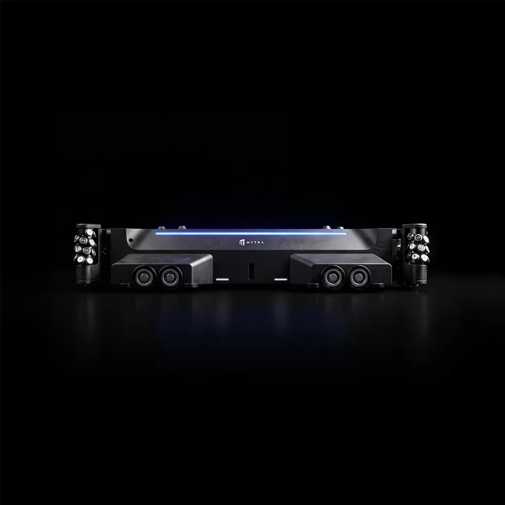 Sleek dark blue and black tanker truck with dual rear axles shown in profile against a black background, by Alberto Essesi.