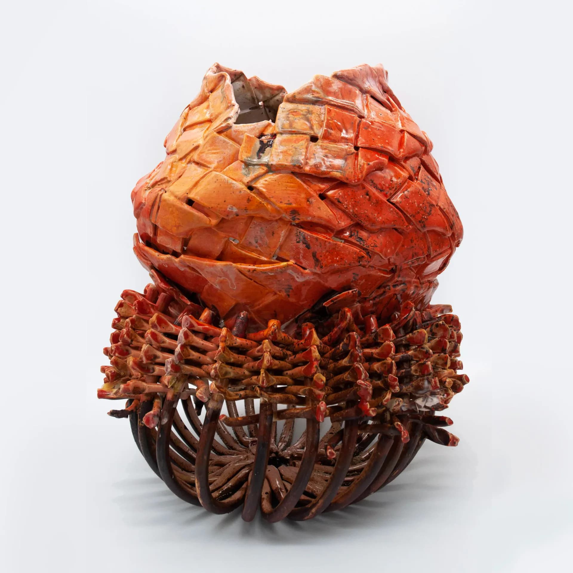 Sculptural ceramic form in terracotta and brown tones featuring organic, layered textures and woven base elements, a functional art piece by Anina Major.