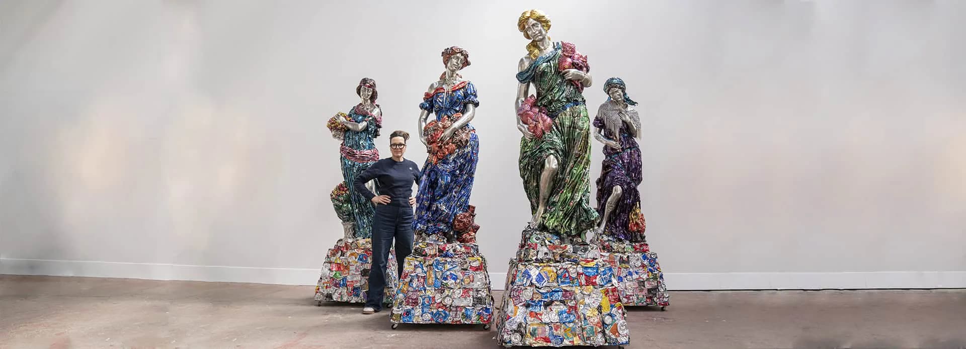 Installation art featuring life-sized figurative sculptures with floral patterned bases arranged in a gallery space by Ann Carrington.