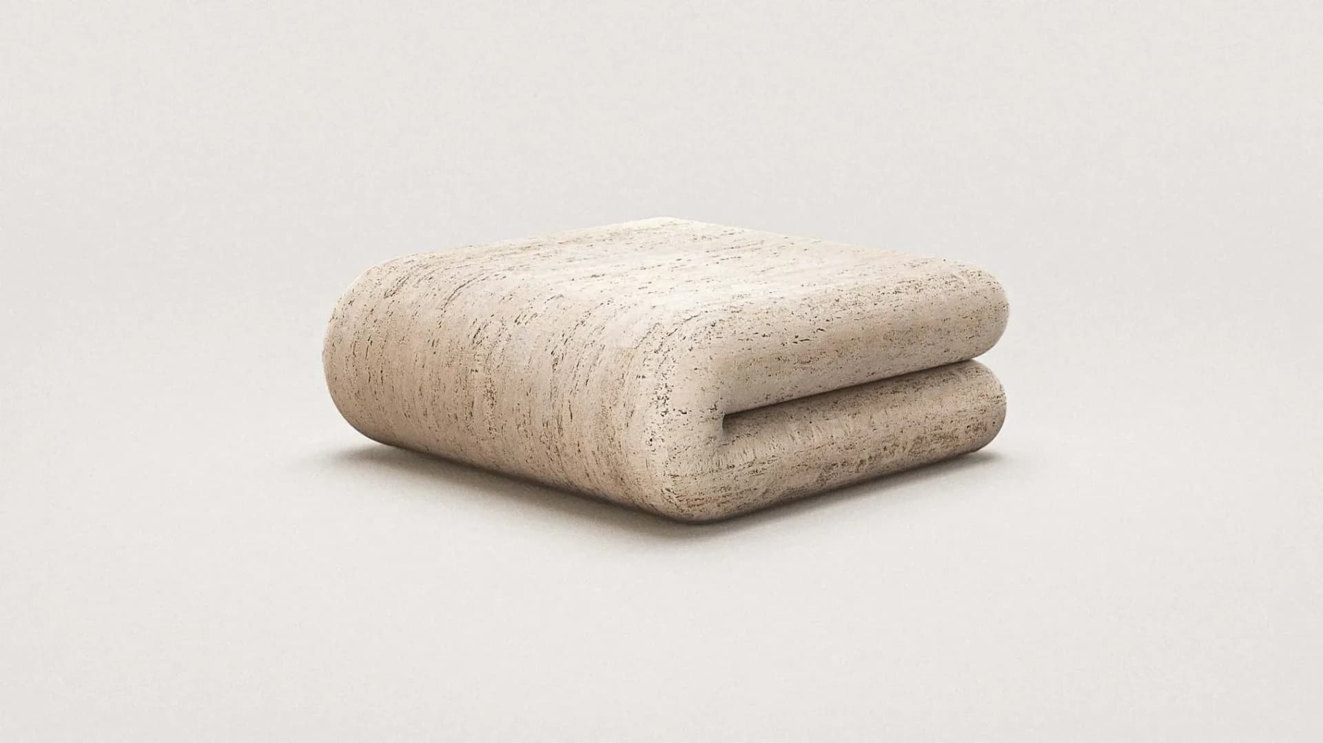 Rolled beige cork or natural fiber textile in a folded configuration against a neutral background by Arthur Vallin.