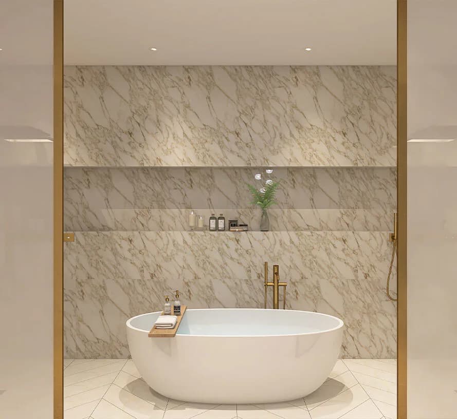 Minimalist marble bathroom with freestanding white oval soaking tub, brass-framed glass partition, and floating vanity shelf by Bailee Klein.
