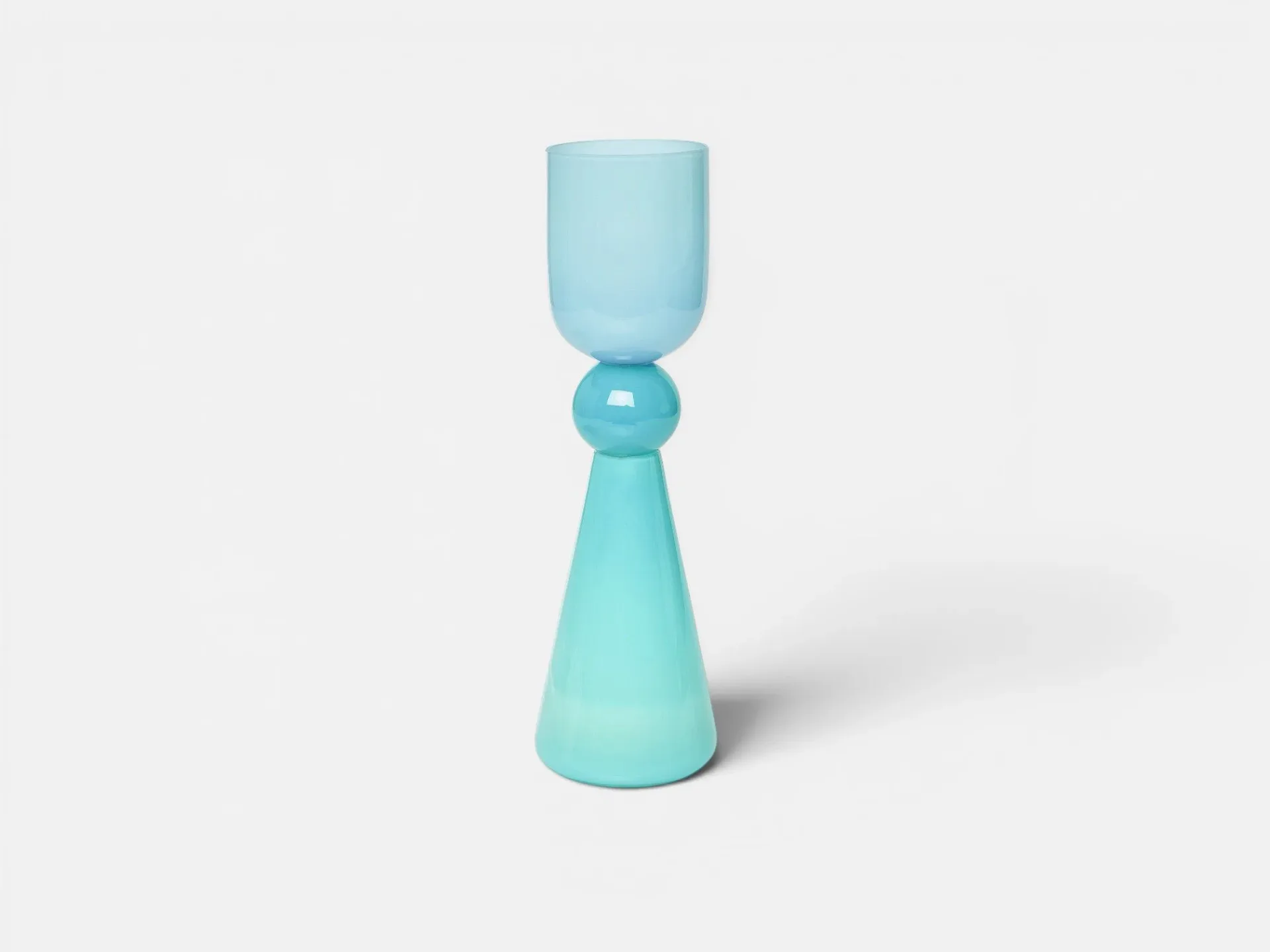 Turquoise sculptural light fixture with stacked geometric forms—cylinder, sphere, and cone—casting a soft shadow against a neutral background, by Bianco Light + Space.