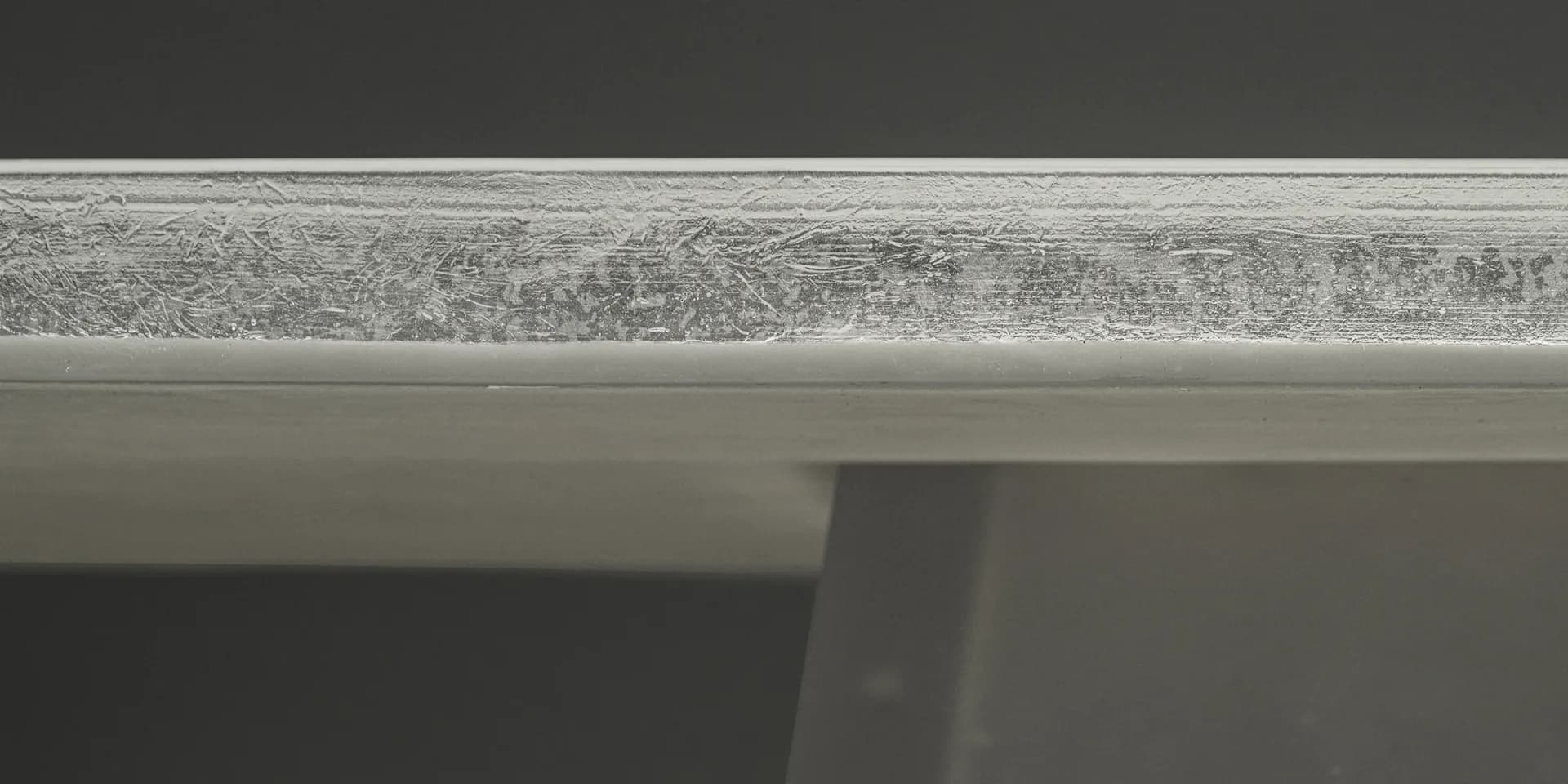 Minimalist ceiling detail showing concrete beam and textured soffit surface in neutral tones by Bowen Liu.