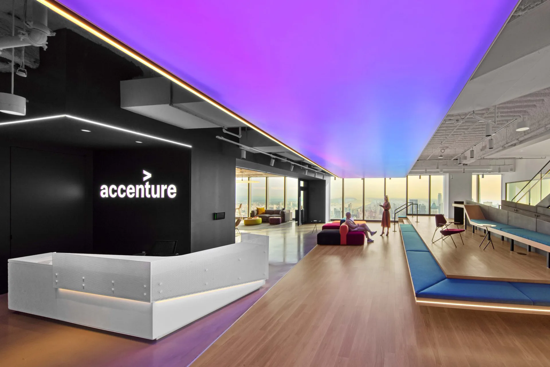 Modern office lobby with purple-lit ceiling, white reception desk, and lounge seating areas with wood flooring by Brian Orter.