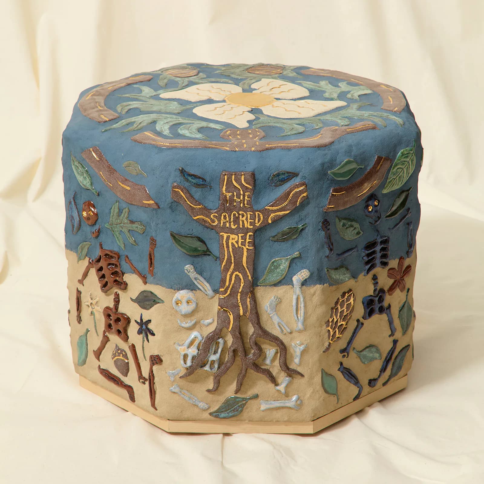 Ceramic cylindrical vessel with blue sky motif at top, earthen tones below, and central gilded sacred tree design, by Chen Chen.