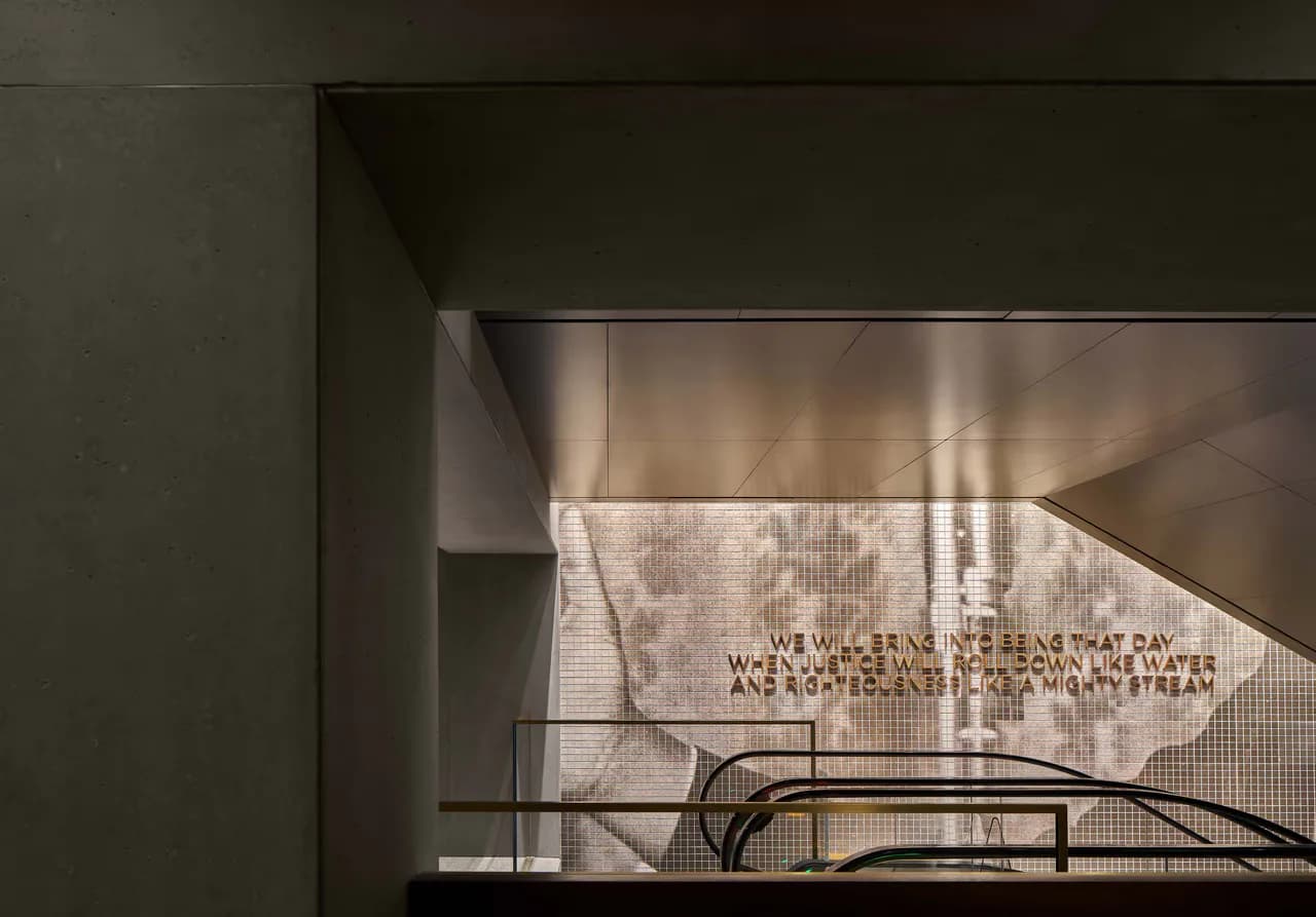 Contemporary interior space with concrete and metal elements, featuring dramatic natural light filtering through translucent panels, photographed by Christopher Cheap.