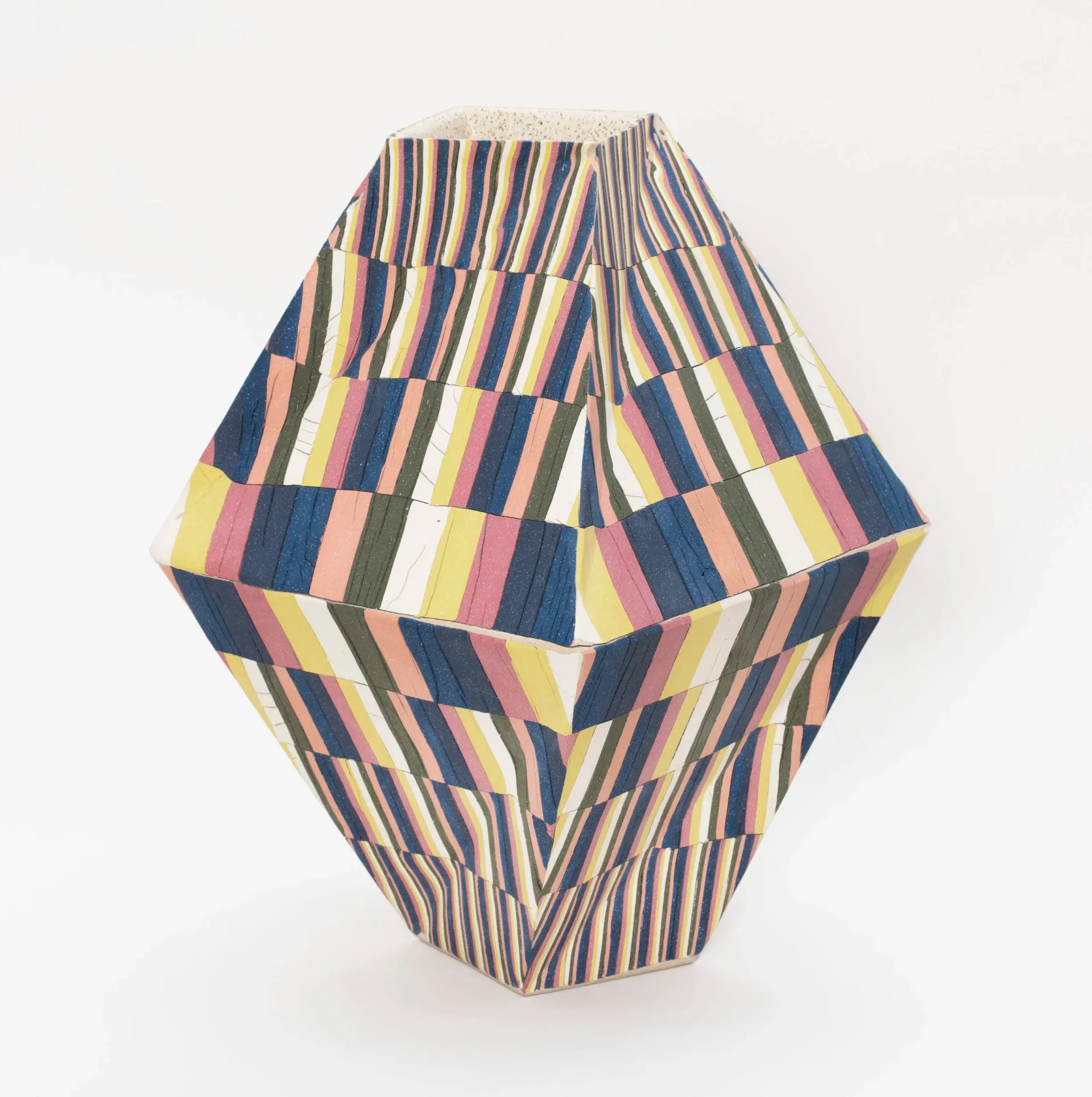 Geometric textile vessel with striped and color-block patterning in navy, yellow, and neutral tones by Cody Hoyt.