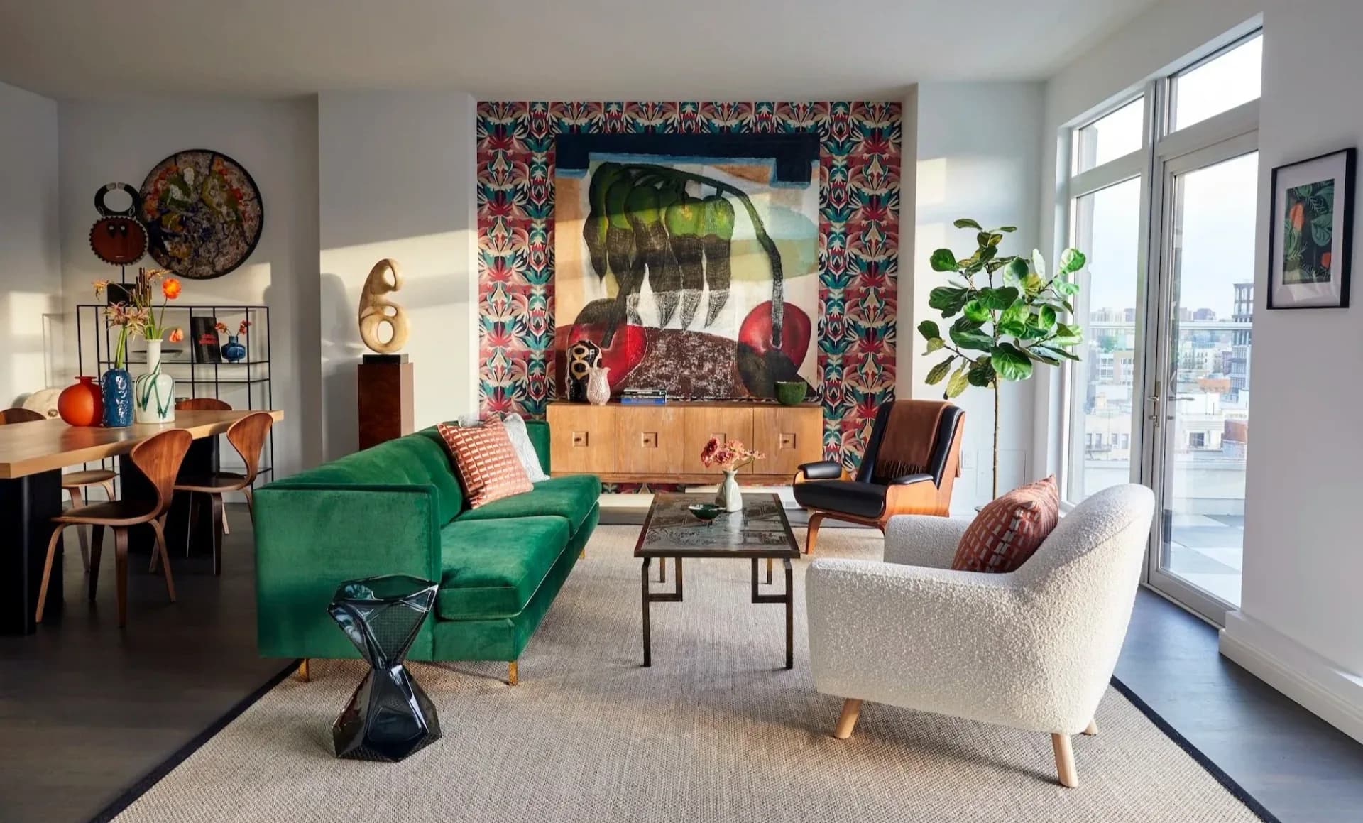Eclectic living room with green velvet sofa, cream boucle chair, colorful gallery wall, and curated vintage furnishings by Courtney McLeod.