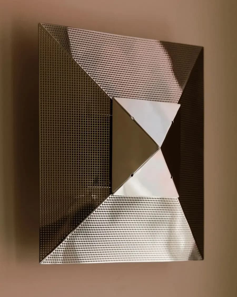 Abstract geometric wall installation with folded mesh and solid panels in brown and white tones, creating dynamic triangular forms by Danny Kaplan.