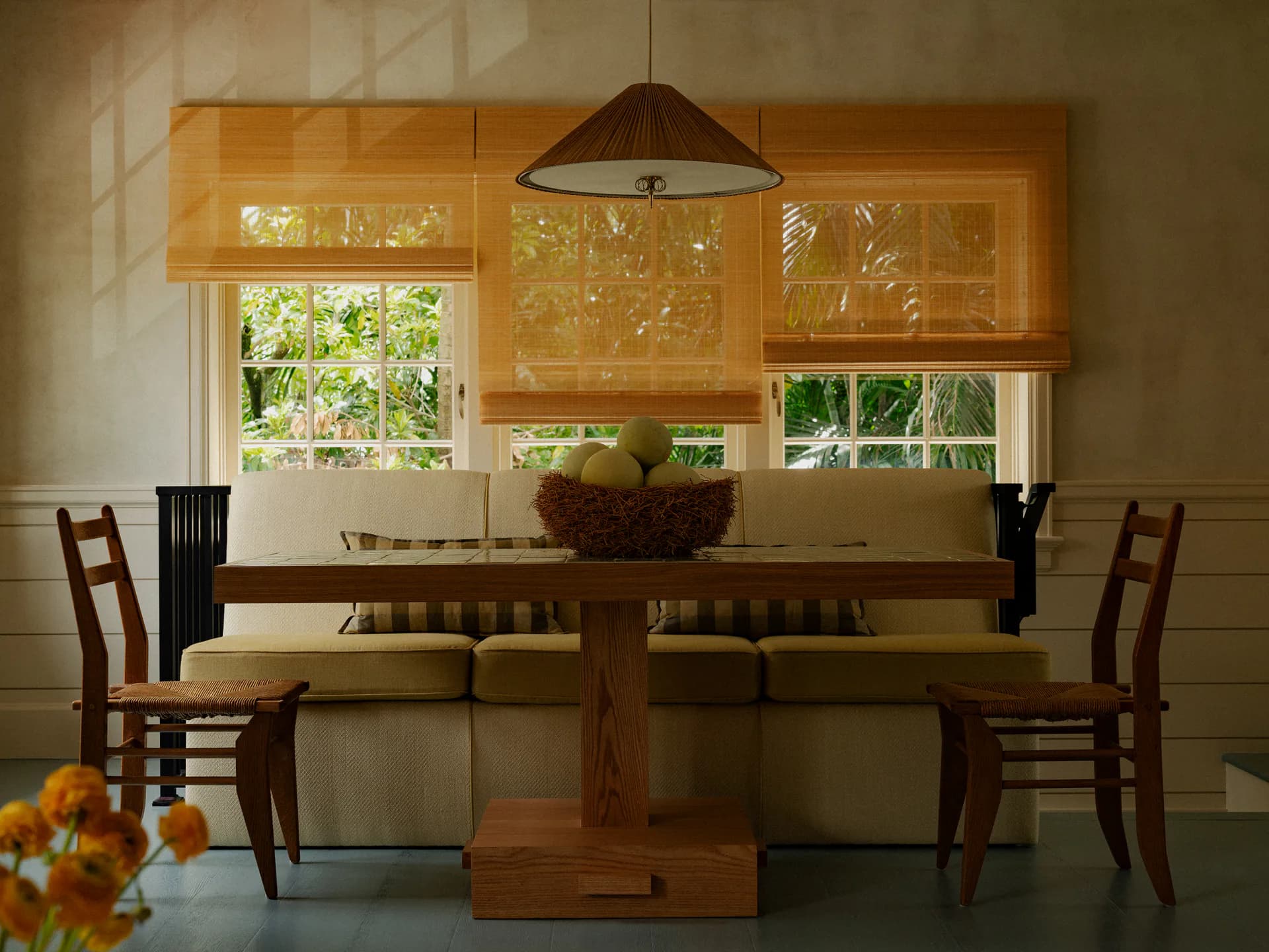 Warm-toned dining room with wooden table, ladder-back chairs, and glazed cabinetry above, featuring pendant lighting and garden views by David Lucido.
