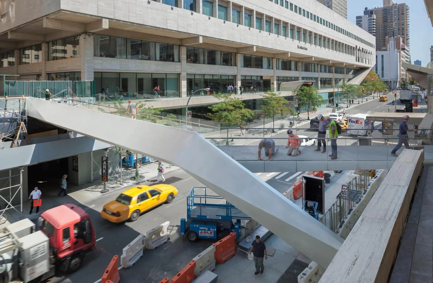 Multi-level urban plaza with concrete ramps, yellow taxi, pedestrians, and modernist building facade by Elizabeth Diller.