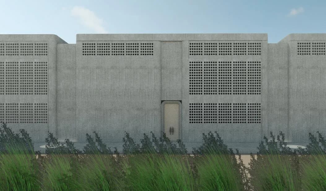 Concrete brutalist building facade with geometric perforated panels and tall grasses in foreground, architectural work by Erika Stahlman.