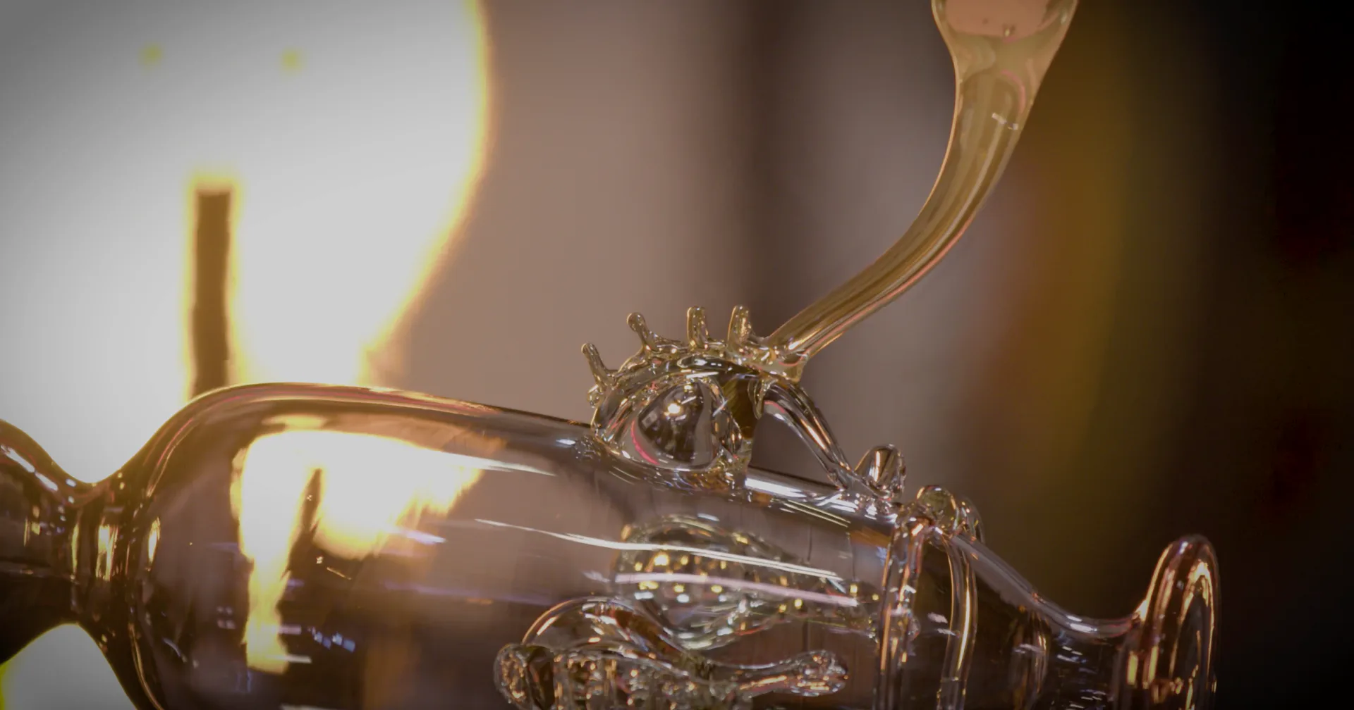 Warm-toned close-up of ornate brass or gold-finished lighting fixture with crystal and metallic details, showcasing luxurious material craftsmanship by Esteban Salazar-Cucalon.