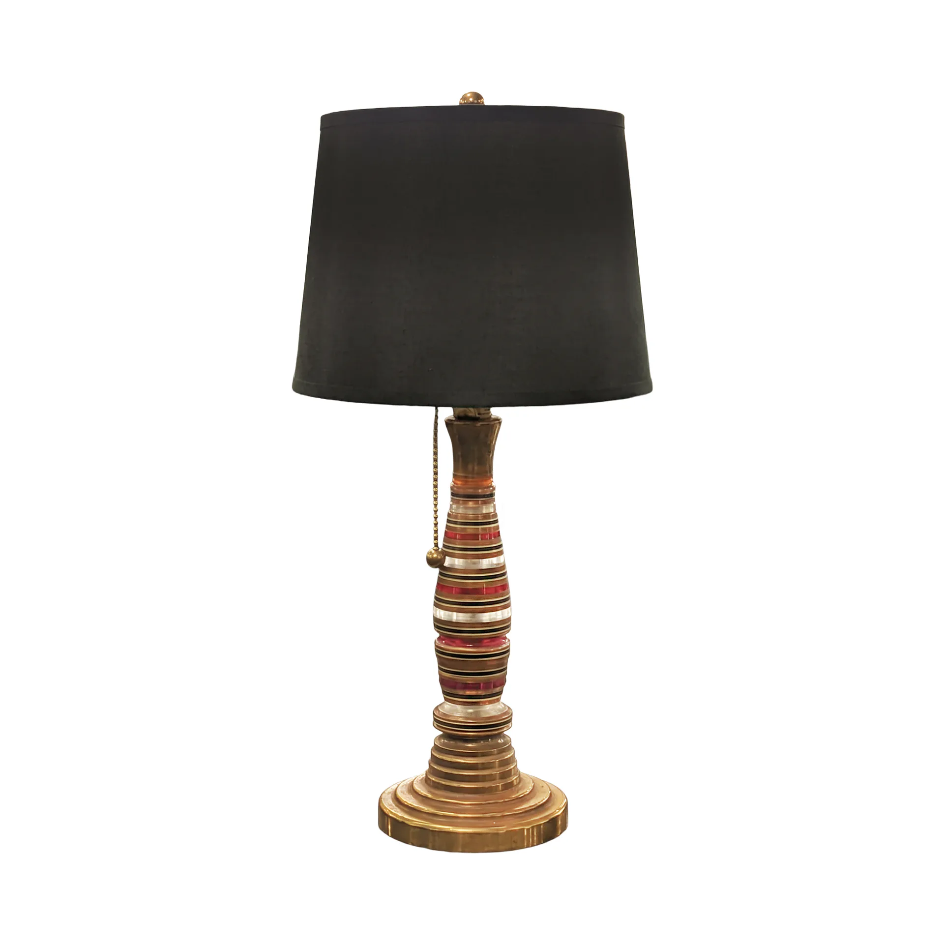 A table lamp with a wooden wrapped base in warm tones and a black cylindrical linen shade, demonstrating product design by Evan Ainbinder.