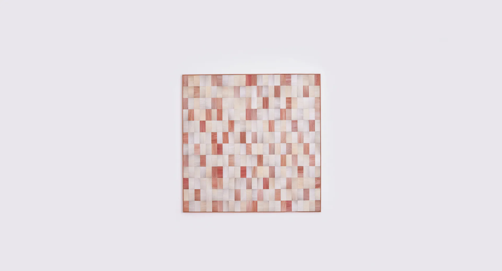 Pixelated terracotta and cream tile installation creating a checkered geometric pattern, by Fernando Laposse.