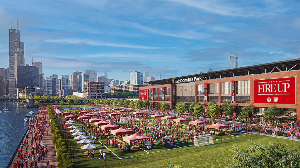 Waterfront event space with red signage and green lawn, Chicago skyline backdrop, designed by Florence Lung.
