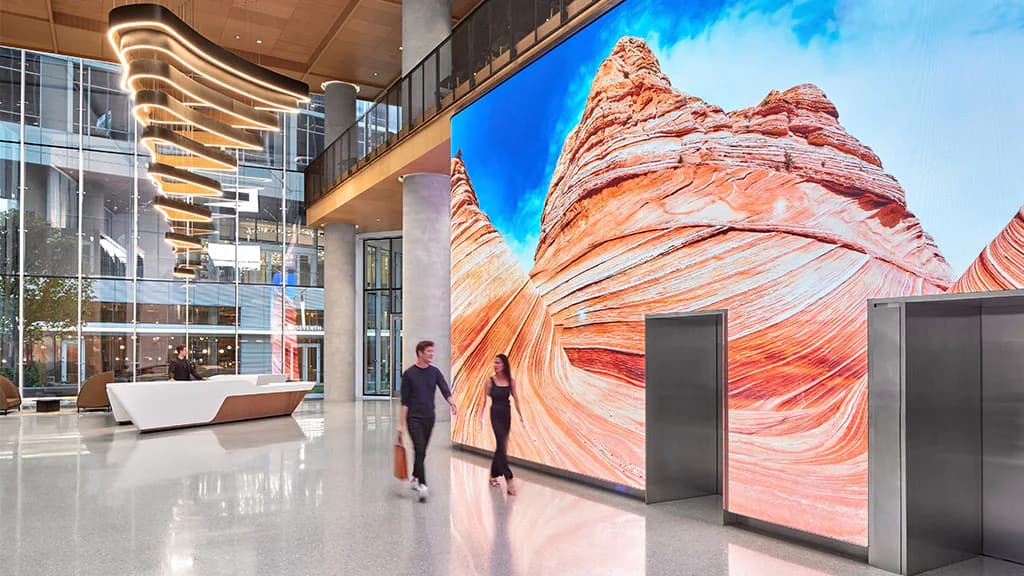 Modern lobby with polished floors and a massive digital wall display showing red-orange canyon rock formations by Florence Lung.