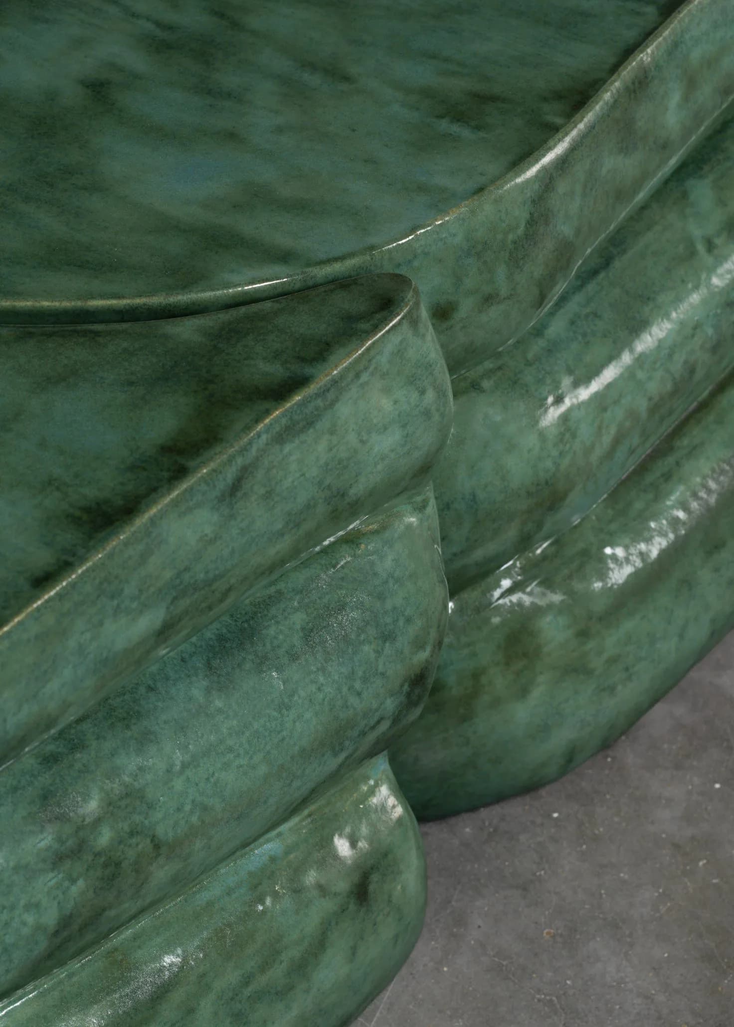 Stacked green patinated metal vessels with curved edges and weathered surfaces, showcasing material craftsmanship by Floris Wubben.