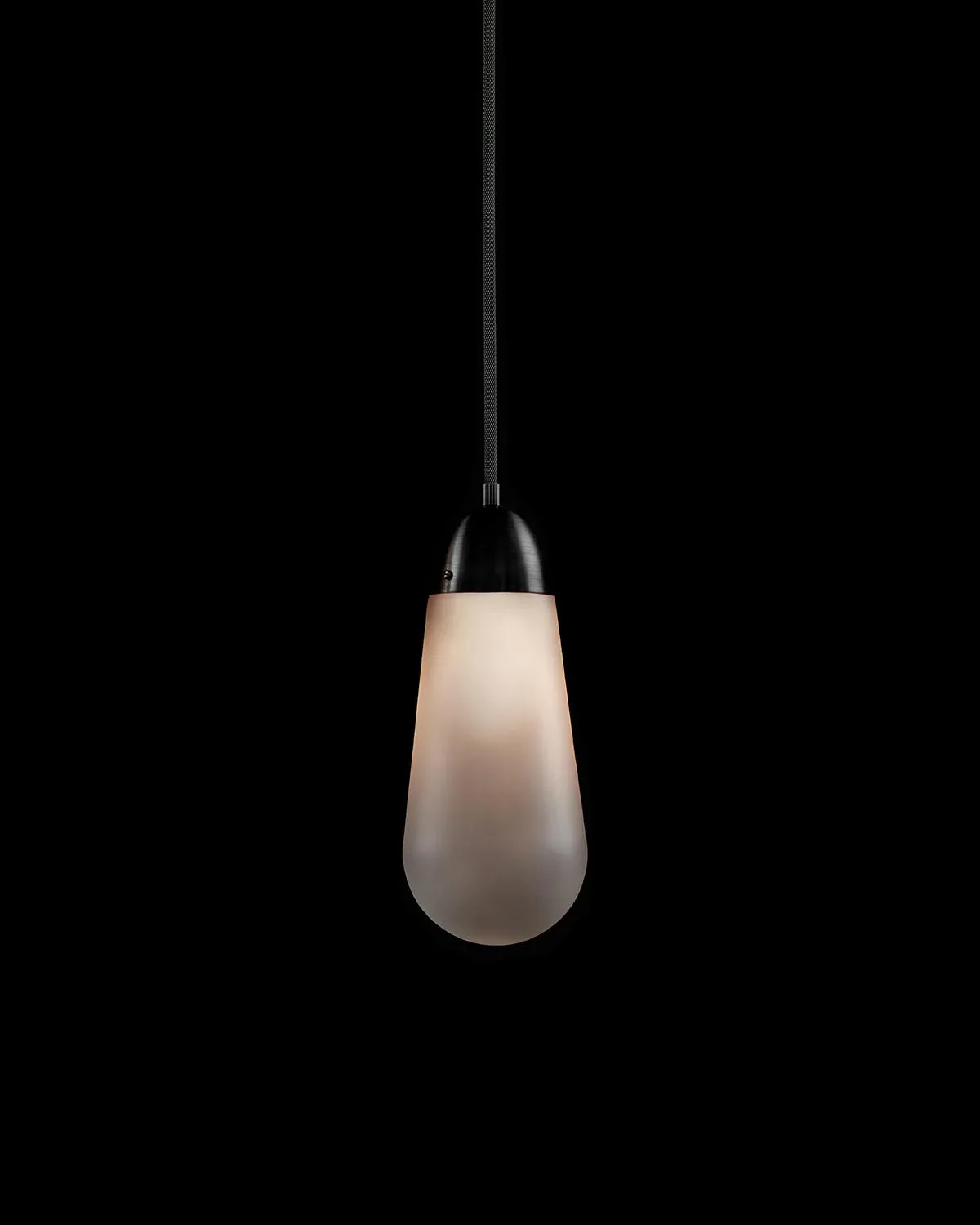 Minimalist pendant light with frosted white glass teardrop shade and black metal canopy suspension by Gabriel Hendifar.