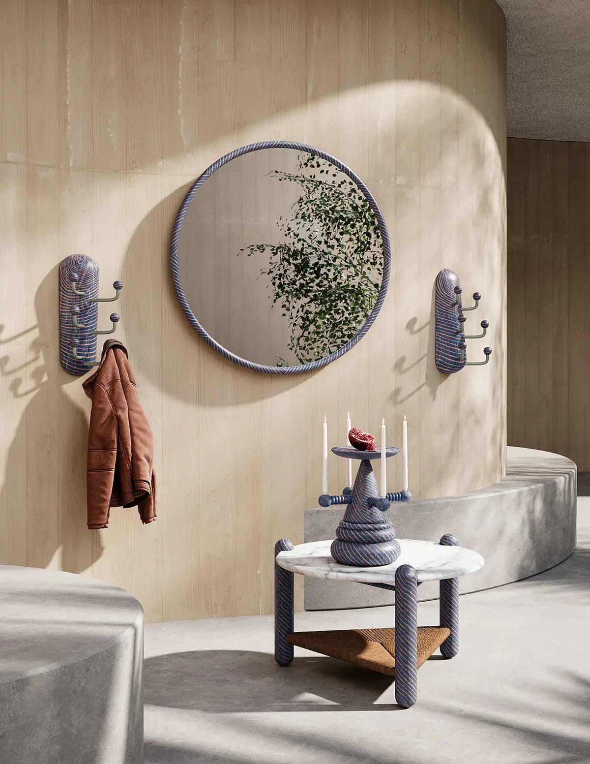 Minimalist bathroom with cream textured walls, circular mirror with climbing ivy, wrapped cylindrical fixtures, and sculptural furniture in soft grays and blues by Hamilton Holmes.