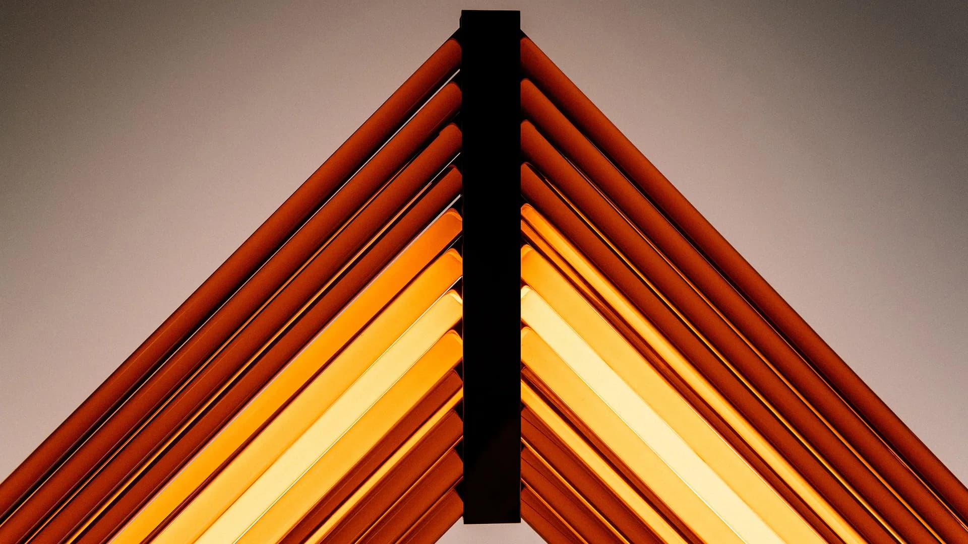 Abstract geometric composition featuring nested triangular forms in red, orange, and yellow gradients with a black vertical element, by Hines Fischer.
