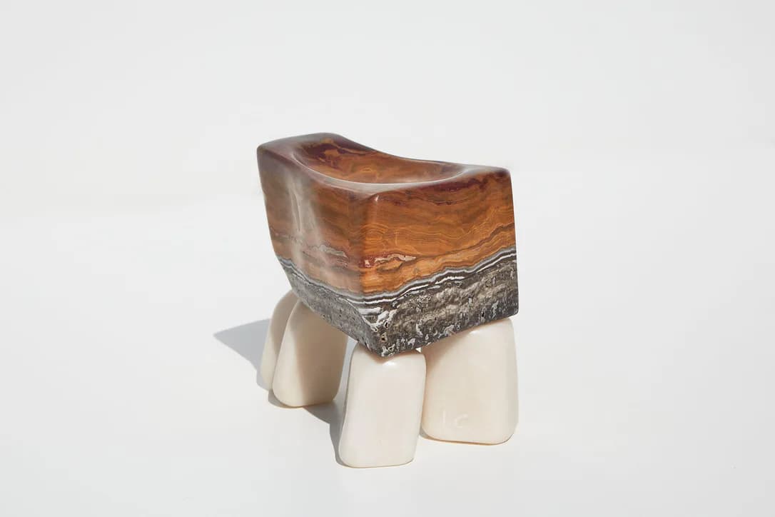 Sculptural wooden and ceramic stool with organic curved brown wood top and cylindrical cream-colored ceramic legs by Ian Collings.