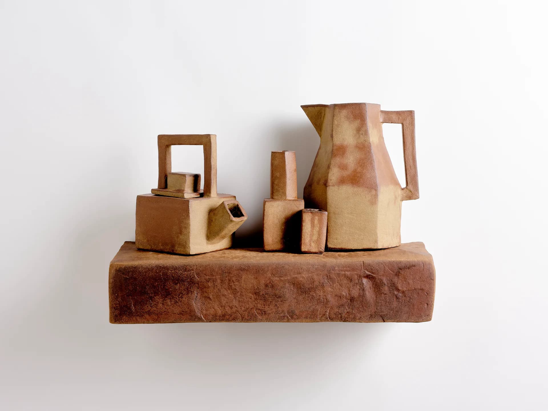 Wooden sculptural arrangement of abstract geometric forms and vessels on a rectangular base, natural materials and tones, by Isabel Rower.