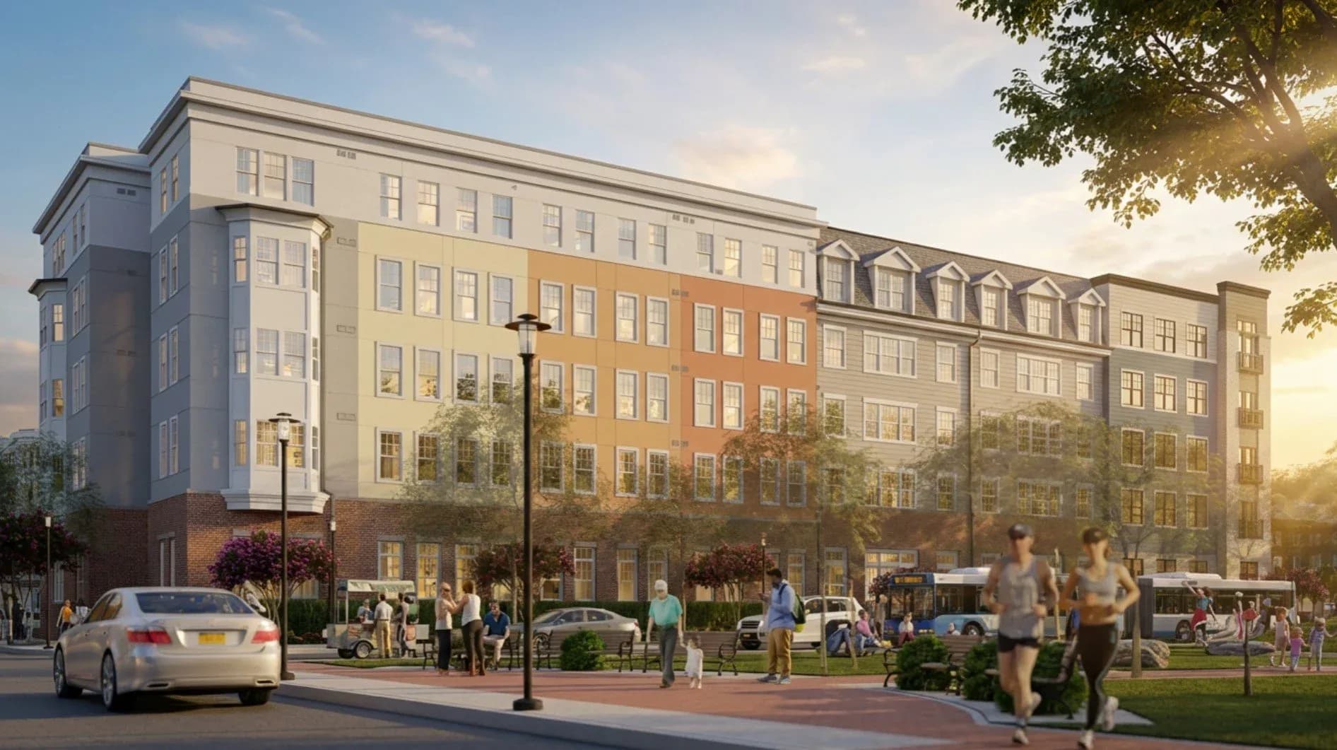 Mixed-use residential building with warm-toned brick and stone facades, ground-floor retail, and mansard roofline designed by Janice Kirschenbaum.