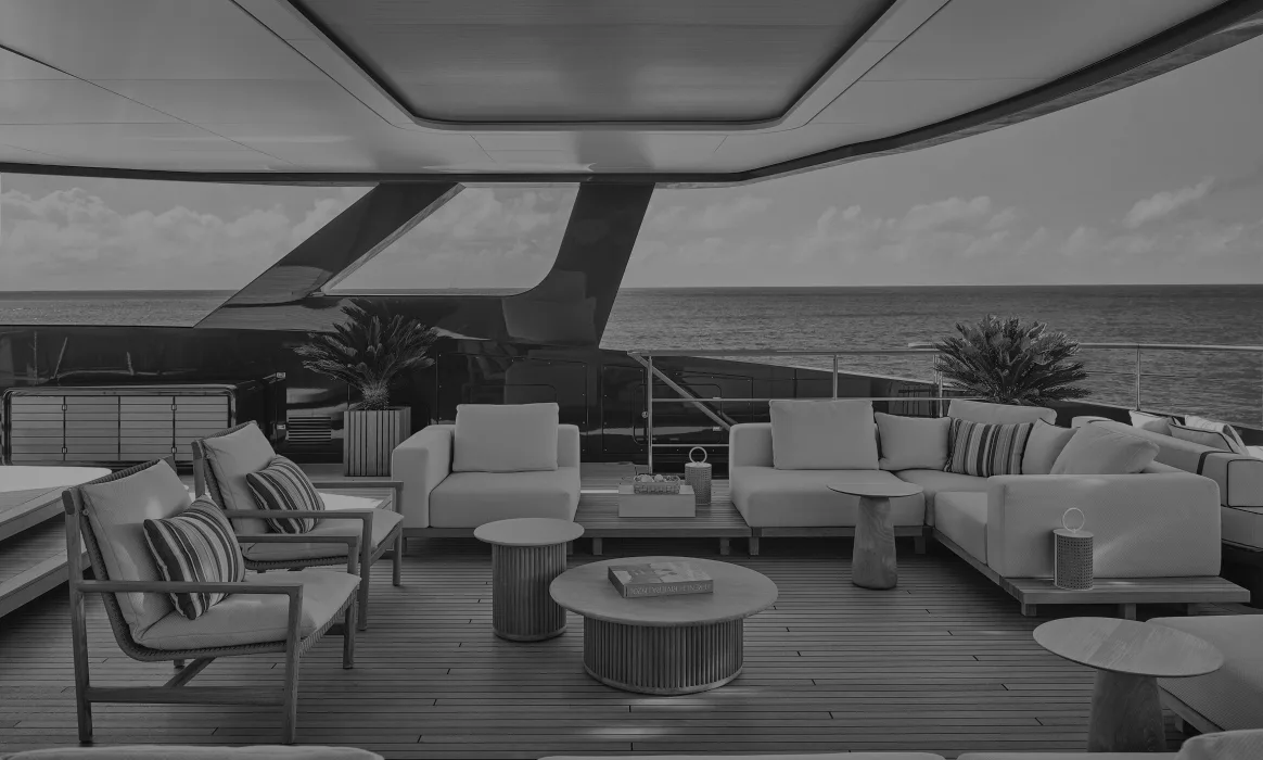 Modern yacht interior lounge with curved architectural elements, neutral upholstered seating, and ocean horizon views by Jennifer Tsai.