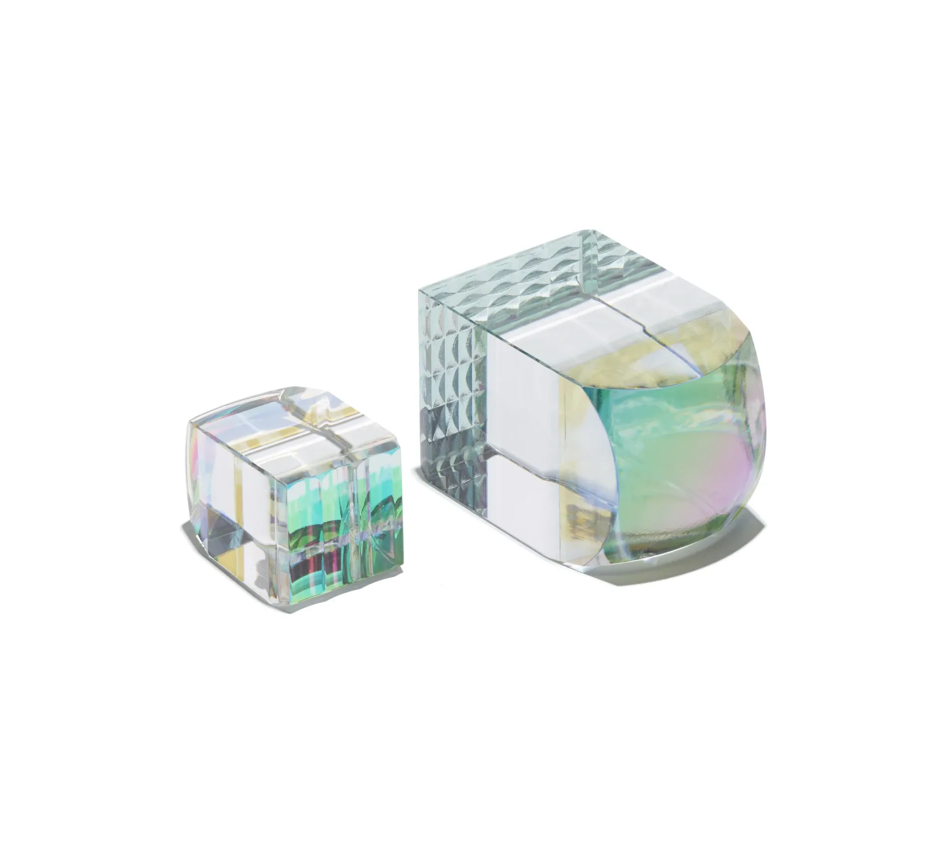 Two transparent acrylic tape dispensers with iridescent and geometric patterned designs in varying sizes by John Hogan.