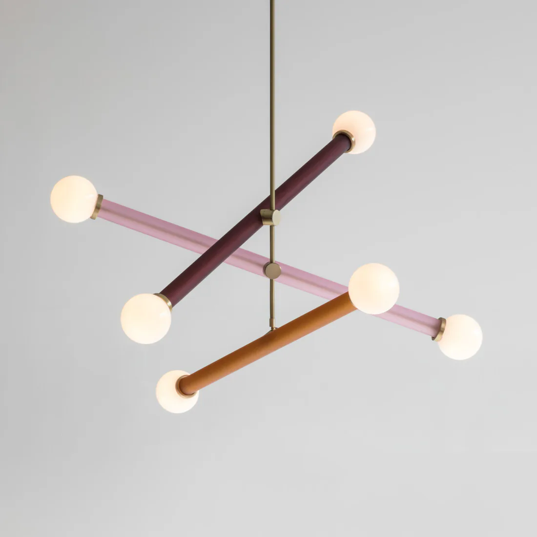 Modern sculptural lighting fixture with cream spheres mounted on angled brass and wood rods in burgundy and bronze tones by Josh Metersky.