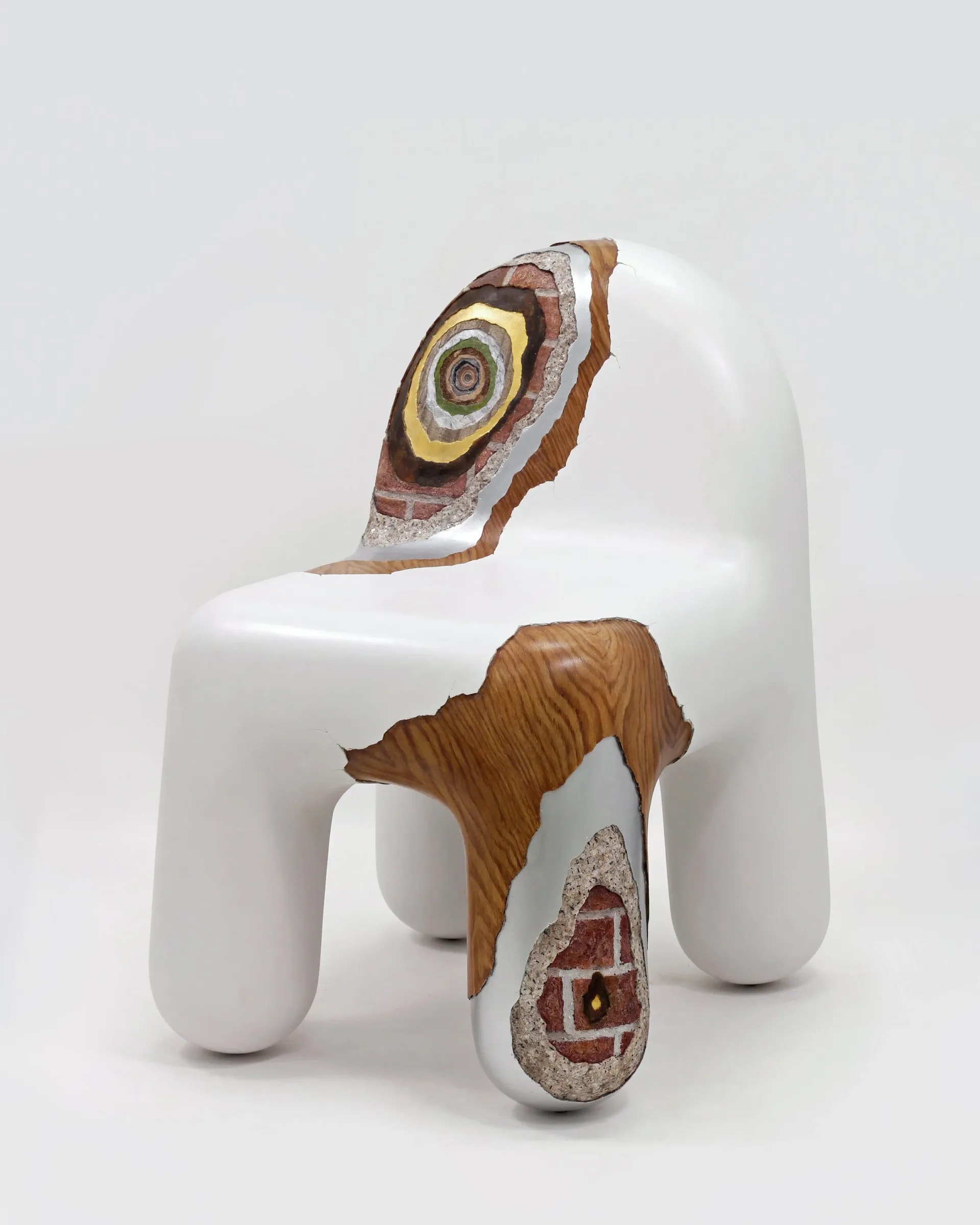 White sculptural chair with organic wood-grain elements and decorative circular inlay details, design by Joyce Lin.