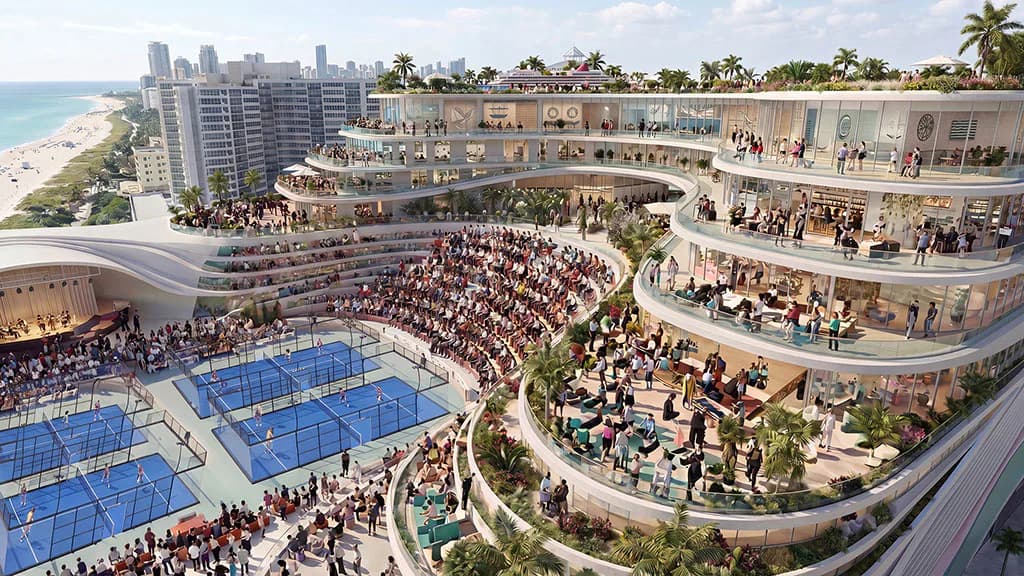 Aerial rendering of a waterfront mixed-use development featuring blue paddle courts, tiered amphitheater seating, curved residential towers, and beachfront promenade with palm trees by Ju Hyun Lee.