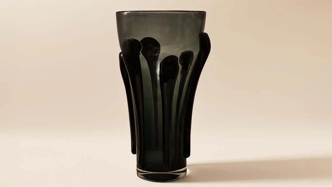 Dark glass vase with sculptural black-glass stem extensions fanned upward, minimalist design by Juan Russo.