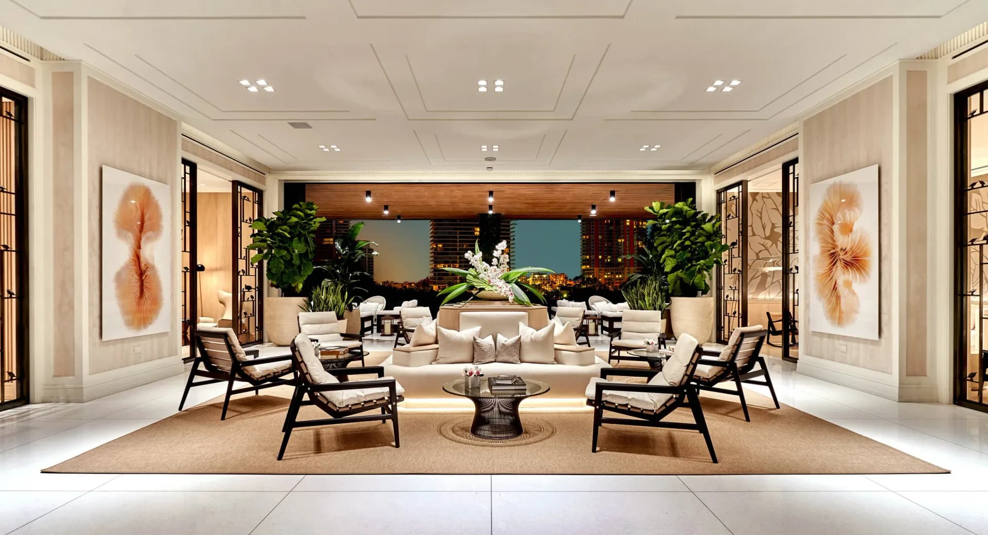 Symmetrical luxury lobby with cream and black palette, paired lounge chairs, central water feature, and living plant installations by Jun Chun.