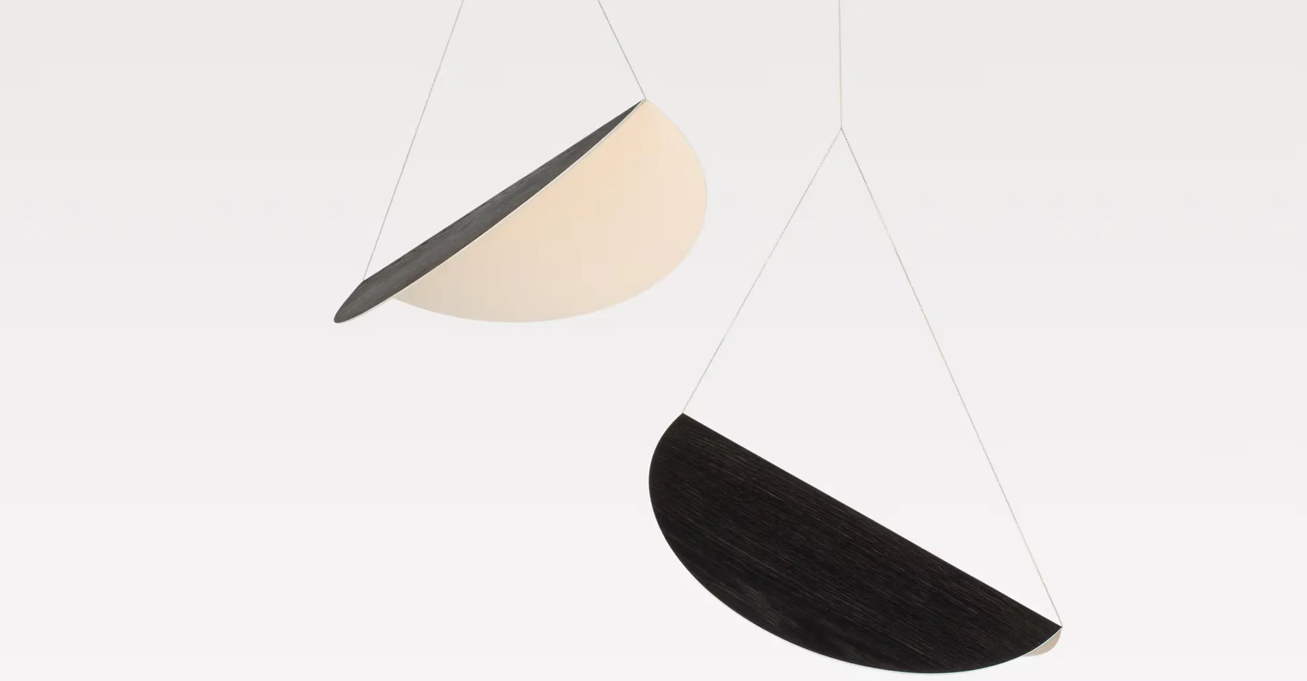 Abstract minimalist composition featuring geometric shapes in cream and black tones suspended against a light background by Karl Zahn.