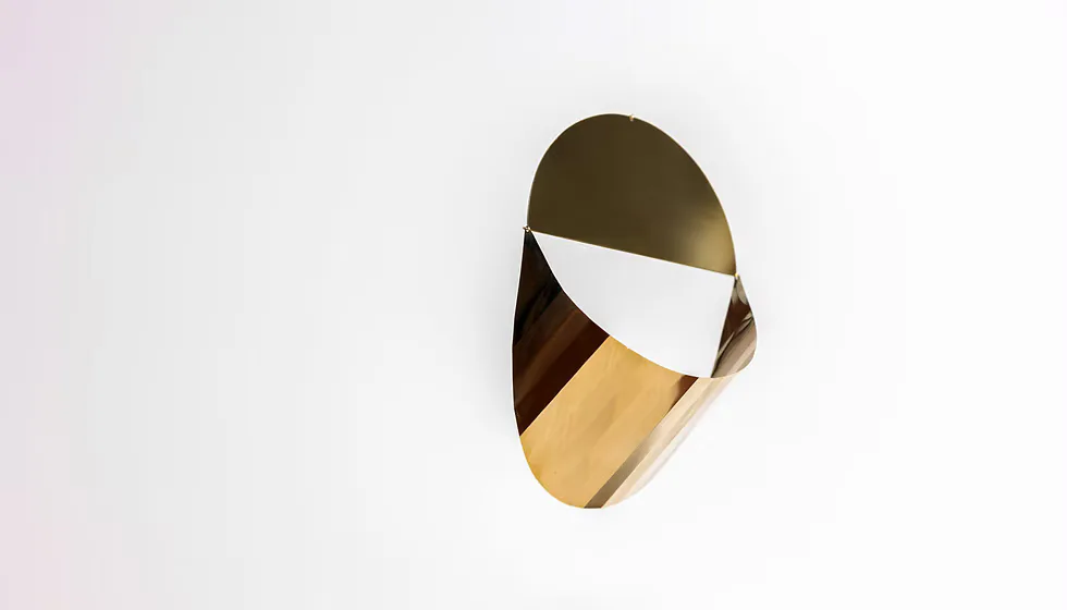 Abstract sculptural form with organic curves in bronze, white, and gold materials against a neutral background, by Karl Zahn.