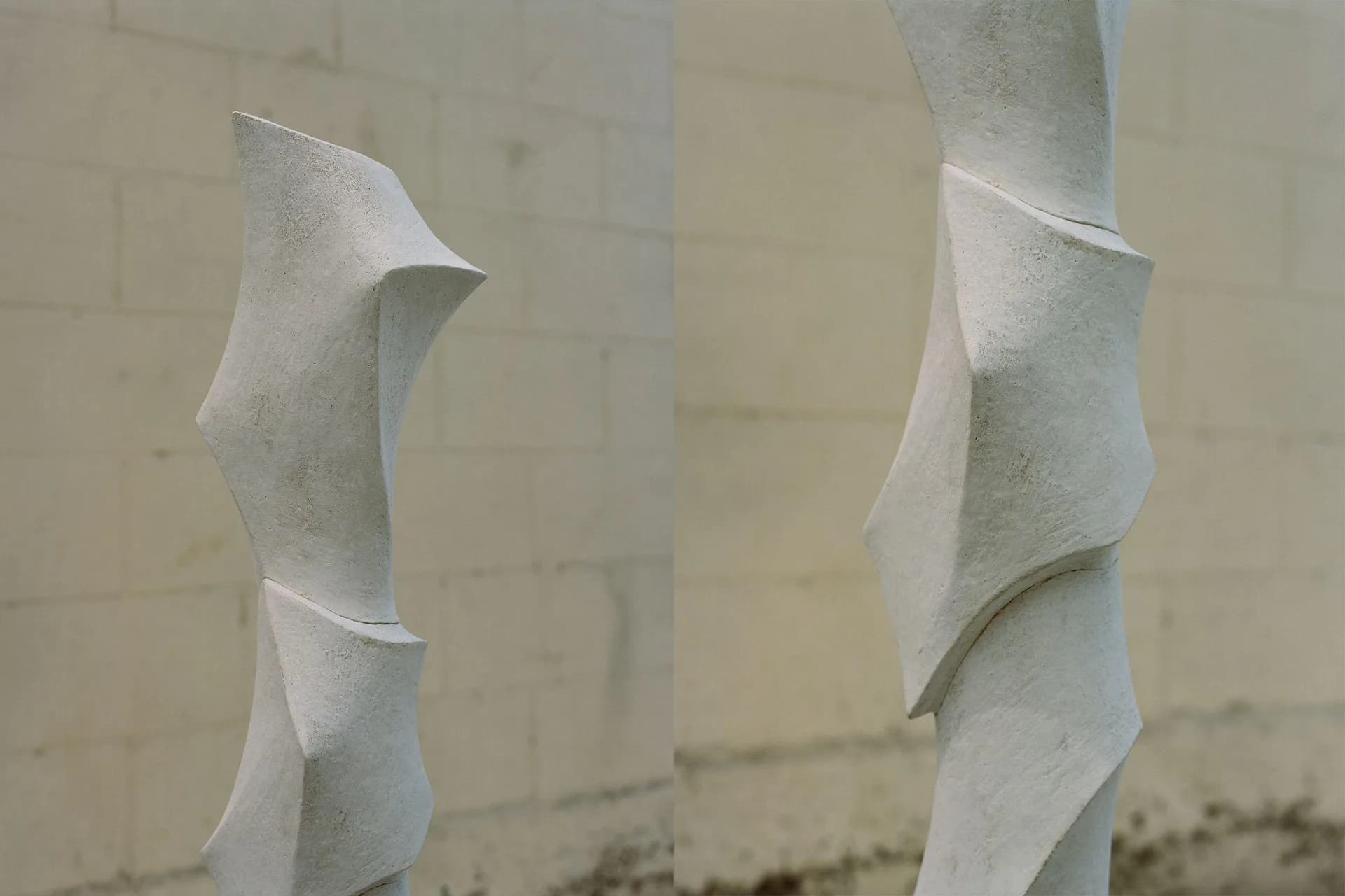 Abstract white sculptural forms with curved surfaces and sharp edges against a neutral background, architectural installation by Kassandra Thatcher.