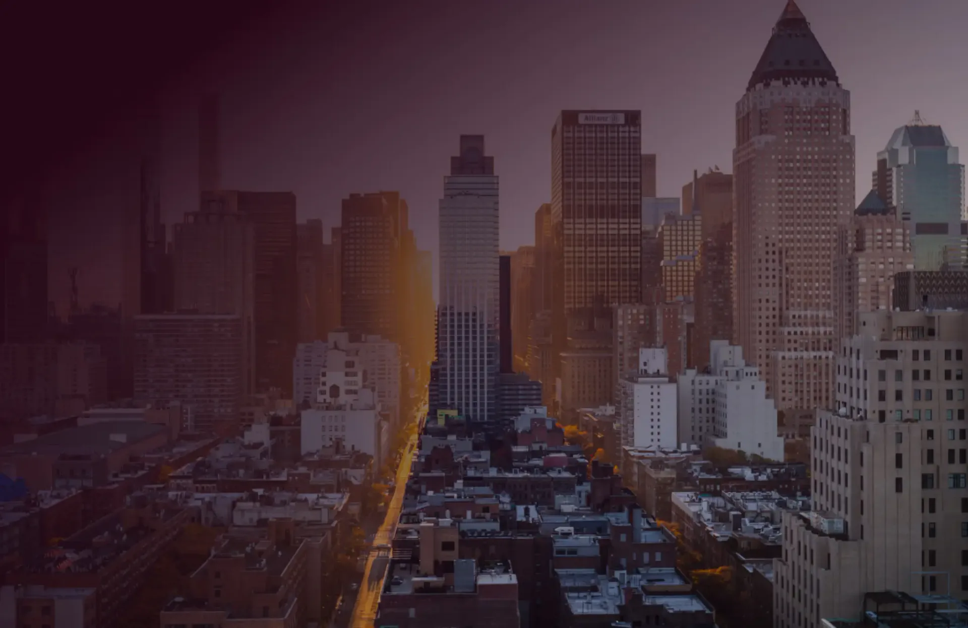 Atmospheric cityscape of Manhattan skyscrapers at dusk with golden street lighting and purple-toned sky, architectural visualization by Kate Cuadro.