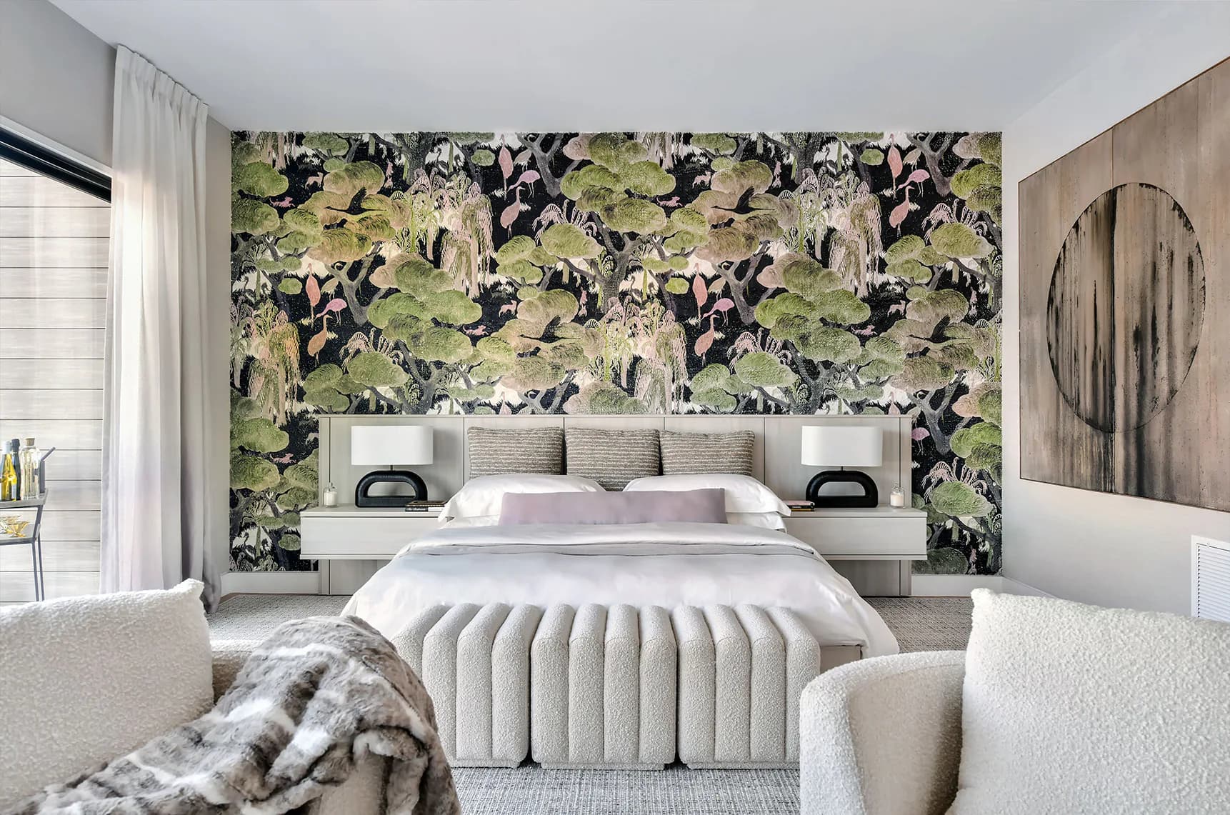 Modern bedroom with botanical wallpaper accent wall, upholstered bed, and neutral furnishings by Kim Radovich.