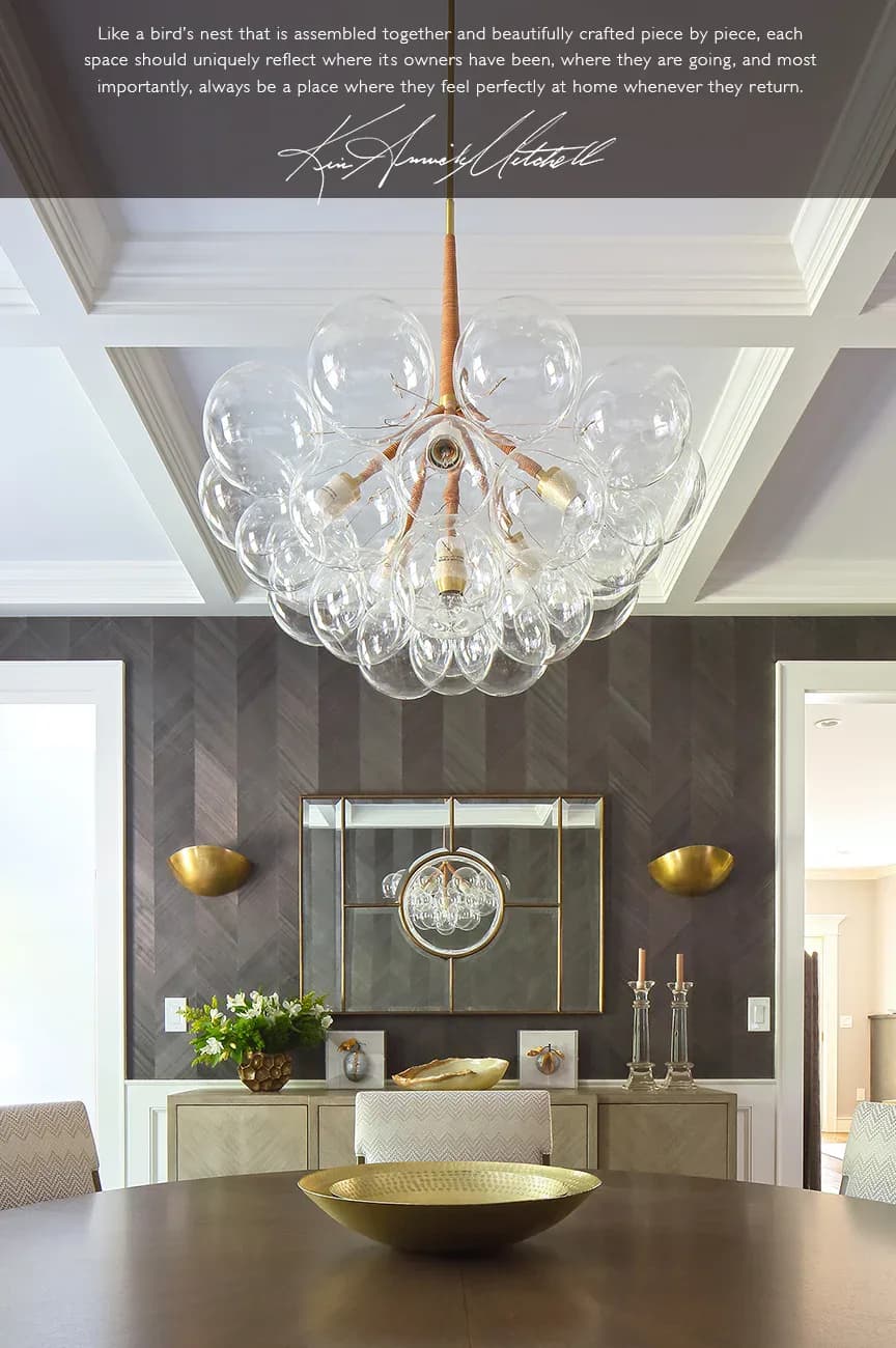 Modern dining room with dark striped wallpaper, brass globe pendant light, and cream built-in cabinetry with brass accents, designed by Kim Mitchell.