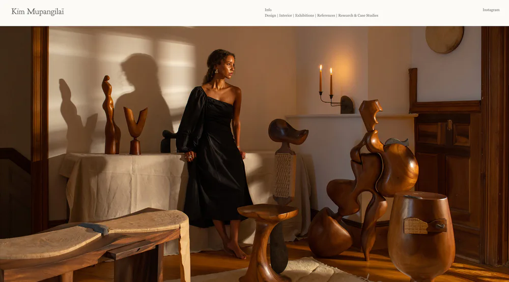 Warm-toned interior with wooden furniture and sculptural pieces, featuring natural light and earthy materials by Kim Mupangilai.
