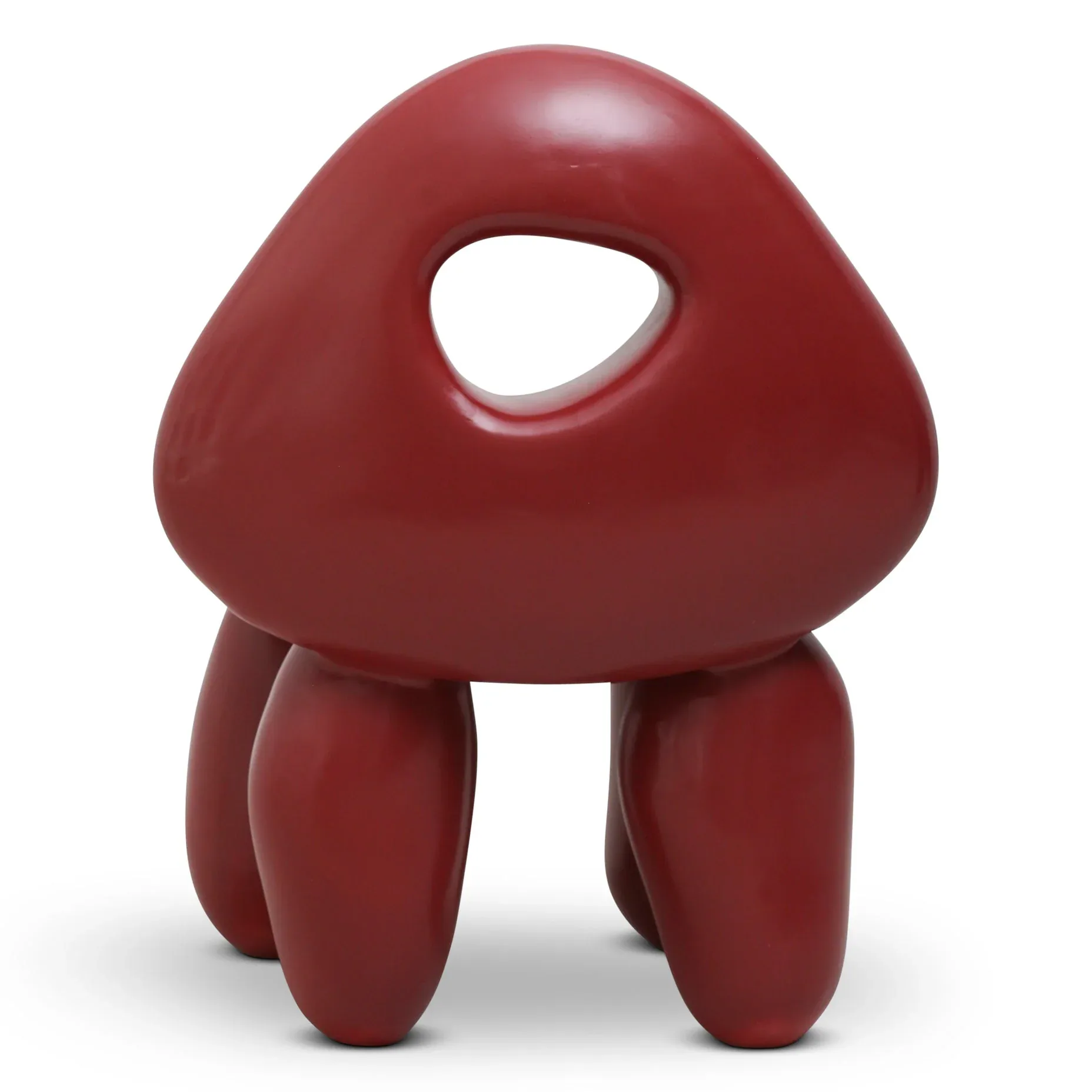 A glossy maroon sculptural form with organic, rounded geometry featuring a triangular top with a heart-shaped opening and four bulbous legs, rendered with smooth surfaces and realistic material shading by Kouros Maghsoudi.