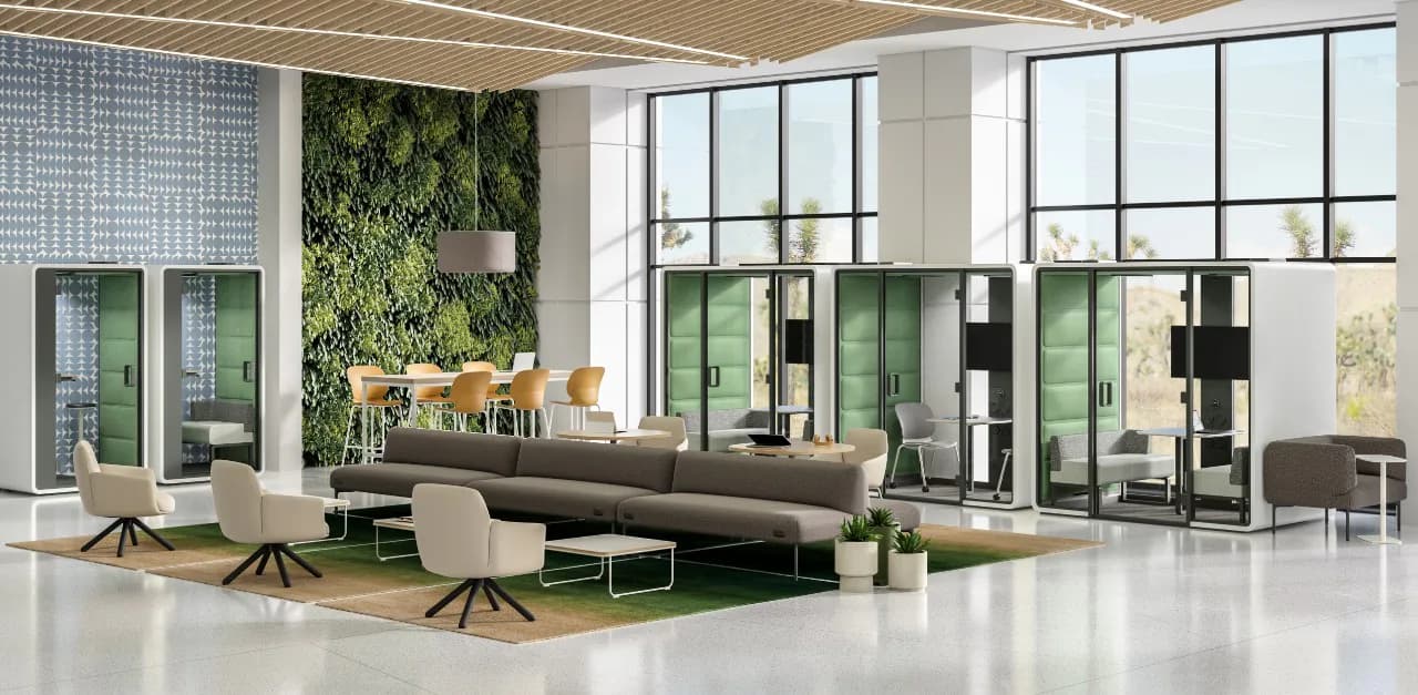 Modern office lounge with dark curved sofa, living wall, floor-to-ceiling windows, and sculptural lighting by Liam Han.