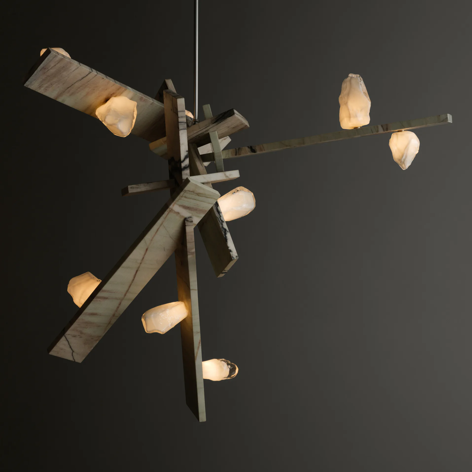 Contemporary pendant light chandelier with raw wood beams and frosted glass teardrop shades arranged in an asymmetrical composition by Lindsey Adelman.