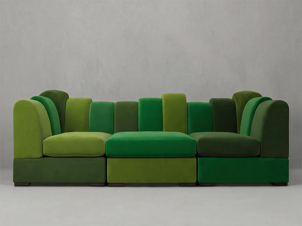 A modular sectional sofa composed of geometric cushioned blocks in lime green and forest green tones arranged in an abstract composition by Liz Bartak.