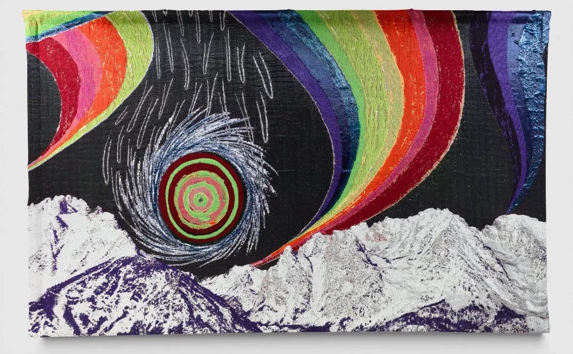 Colorful abstract textile or fiber art featuring concentric circles, curved rainbow stripes, and mountain landscape imagery on black background by Liz Collins.