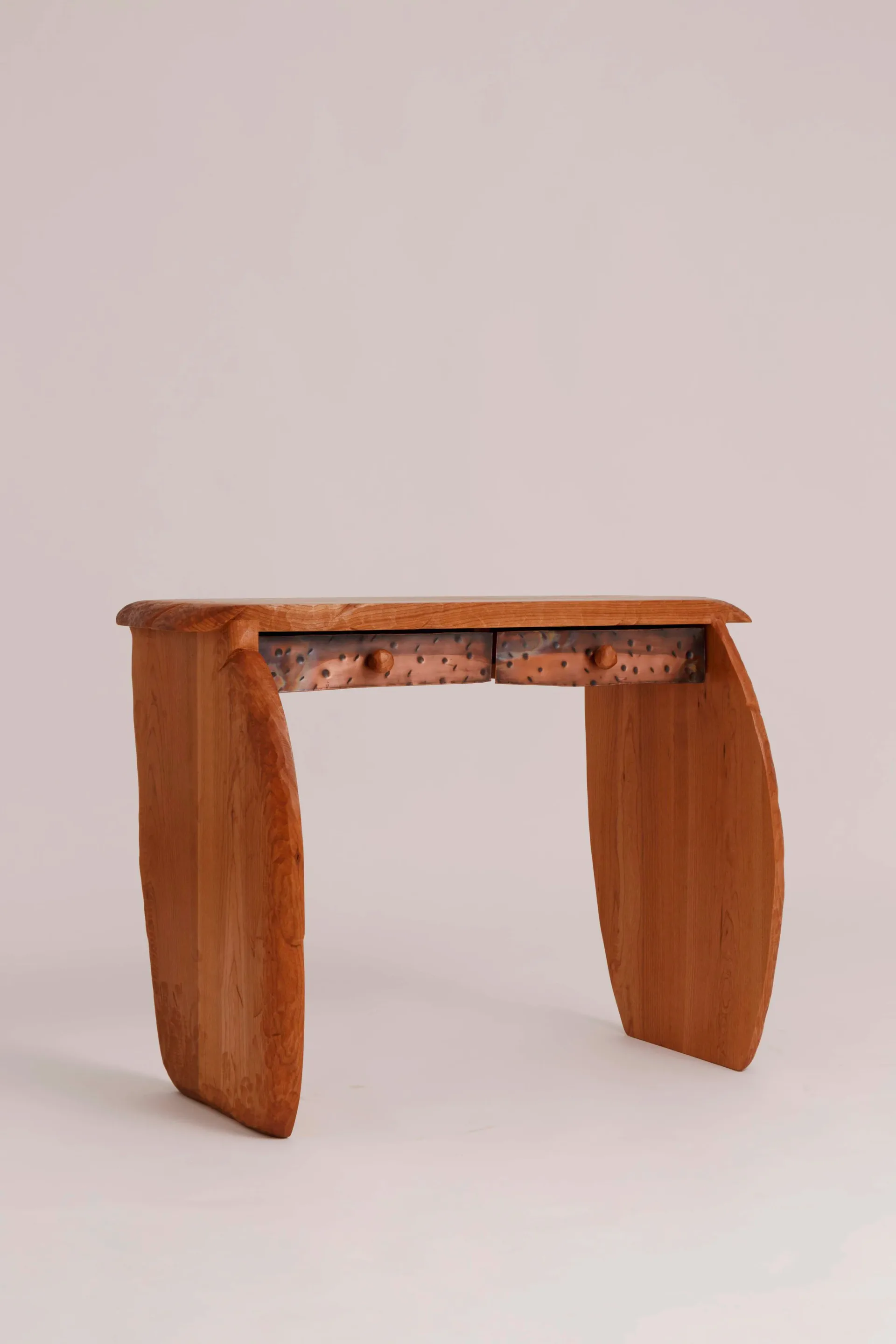 Sculptural wooden console table with curved organic legs and a decorative perforated metal stretcher, by Luke Malaney.