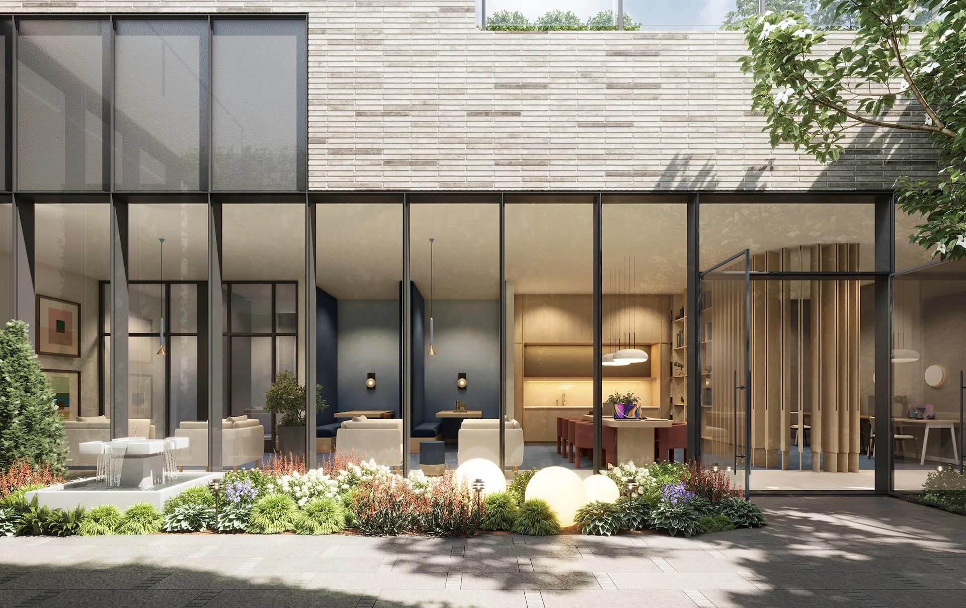 Modern residential exterior with floor-to-ceiling black-framed glass doors and windows, warm interior lighting, light brick facade, and landscaped garden by MacKenzie Reid.